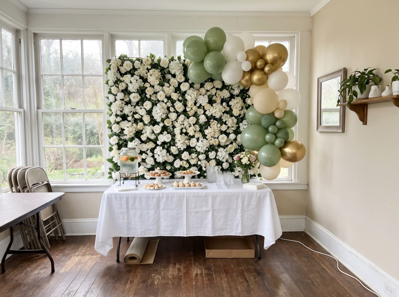 Flower wall backdrop with a sage balloon garland