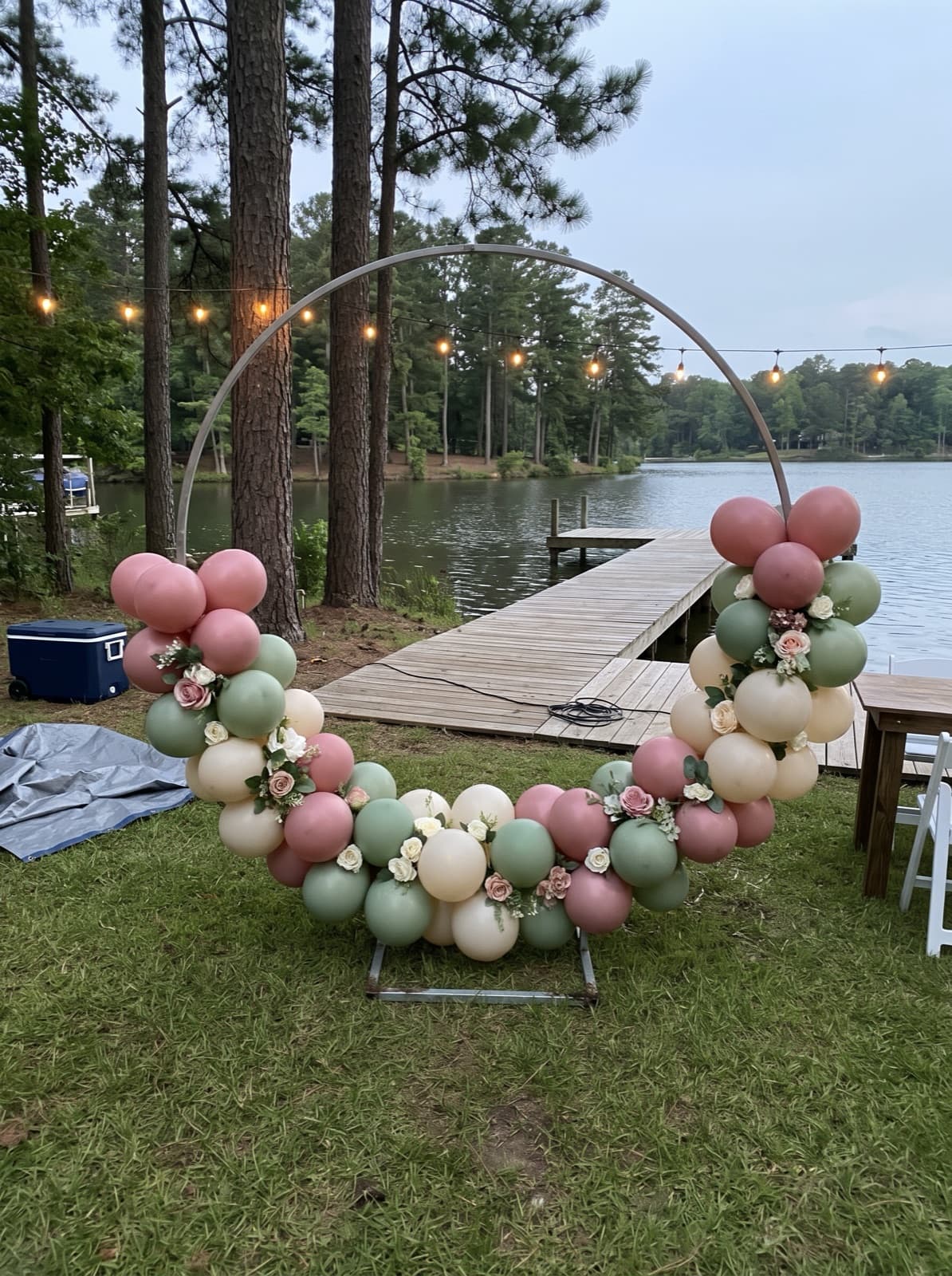 Balloon hoop backdrop with florals on a lakeside lawn