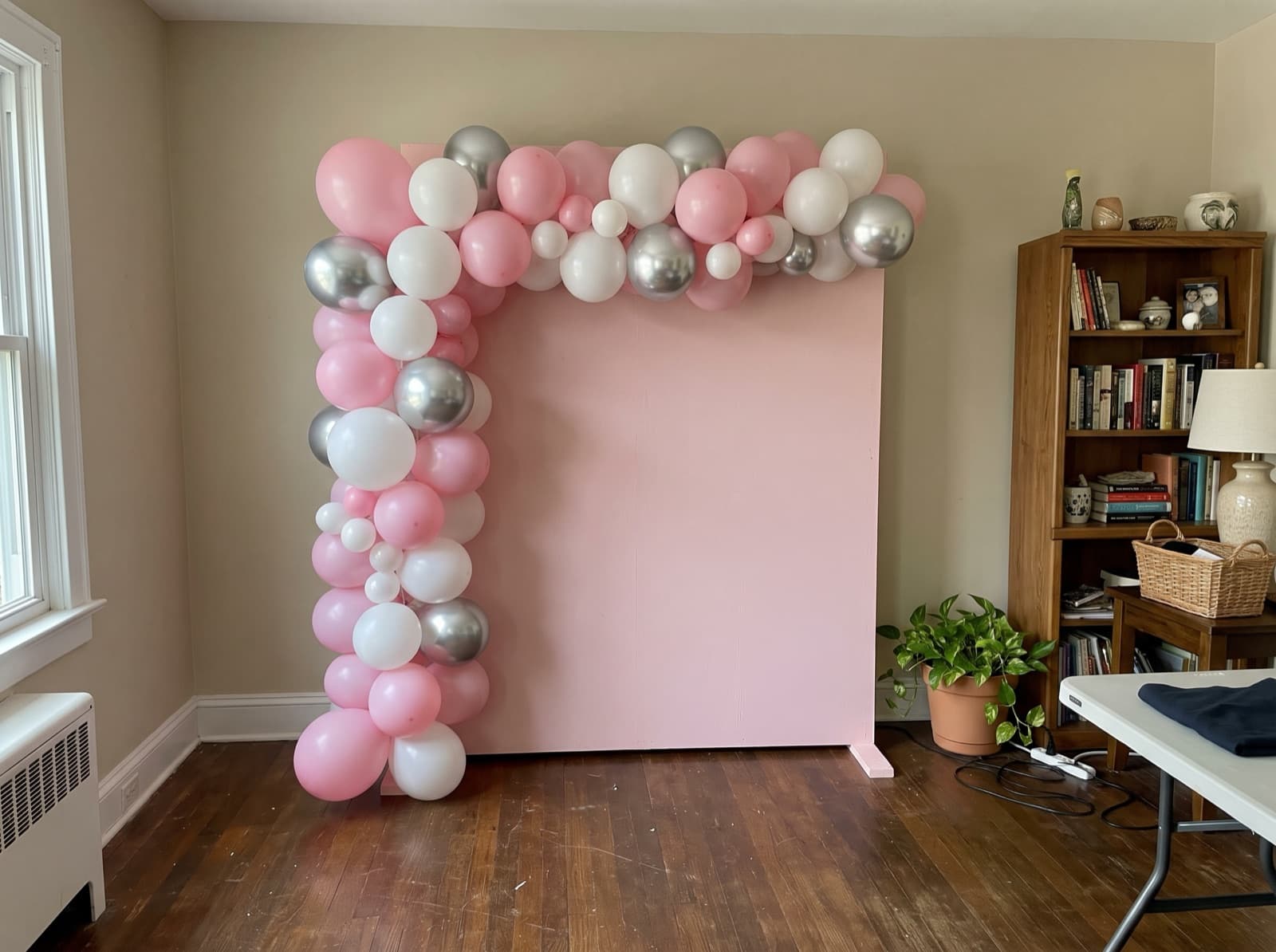 Square backdrop with a balloon garland up one side