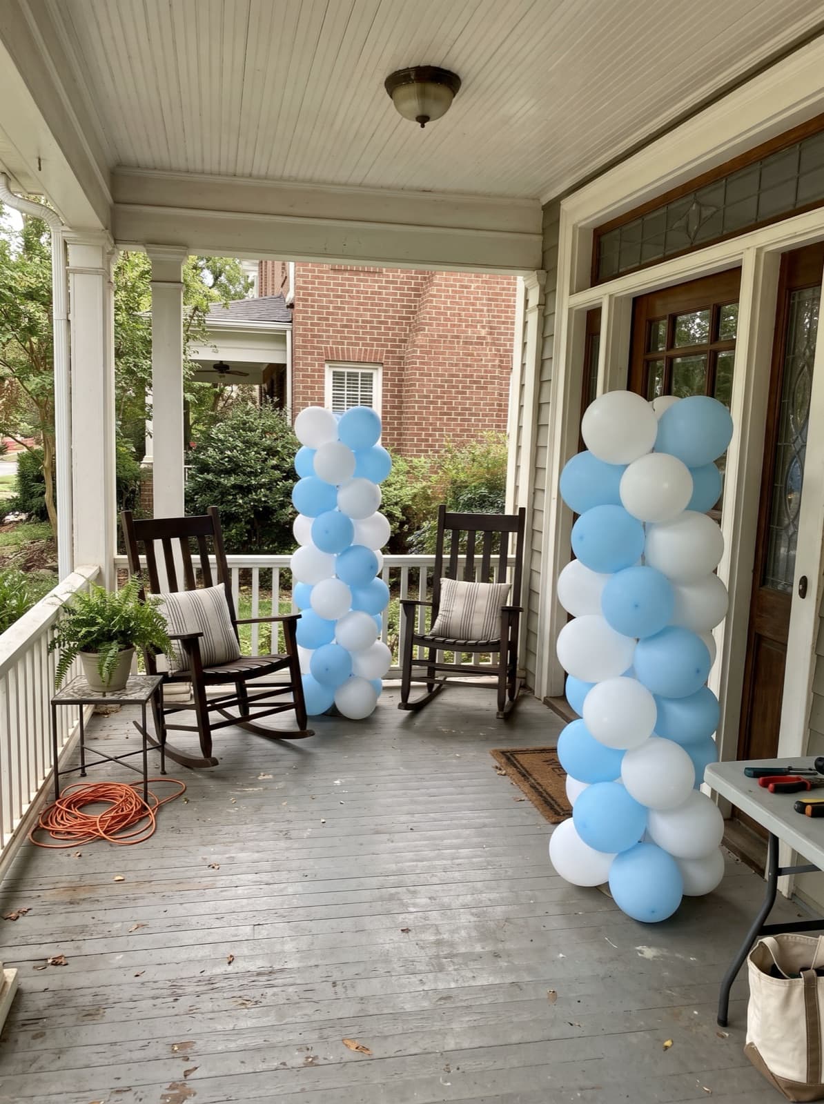 Pair of spiral balloon columns at a porch front door