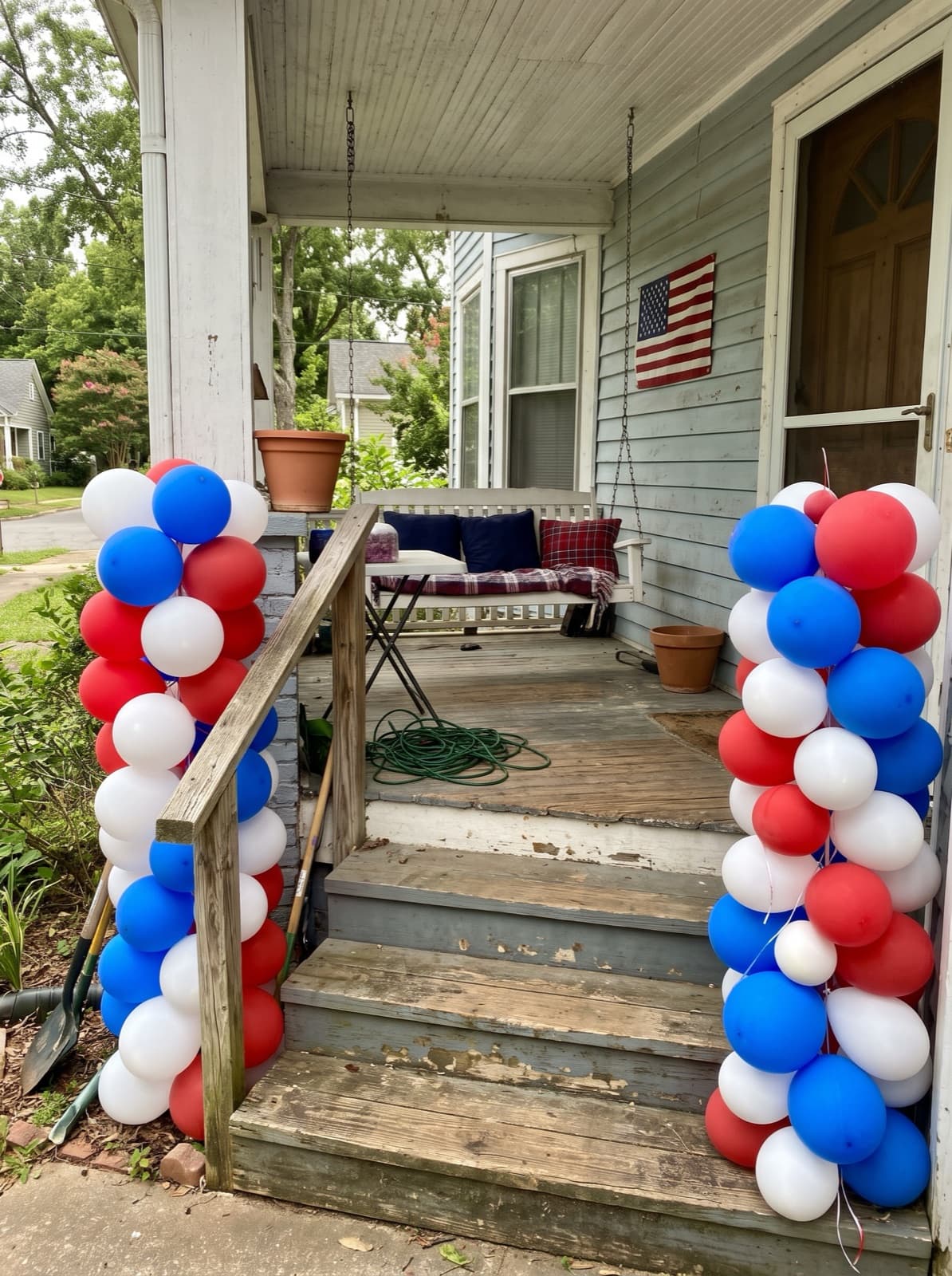 Red, white and blue spiral balloon columns at porch steps