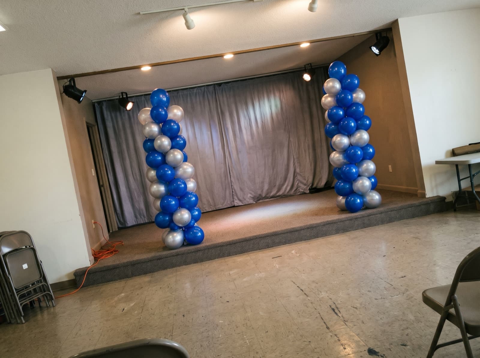 Tall balloon columns on each side of a stage