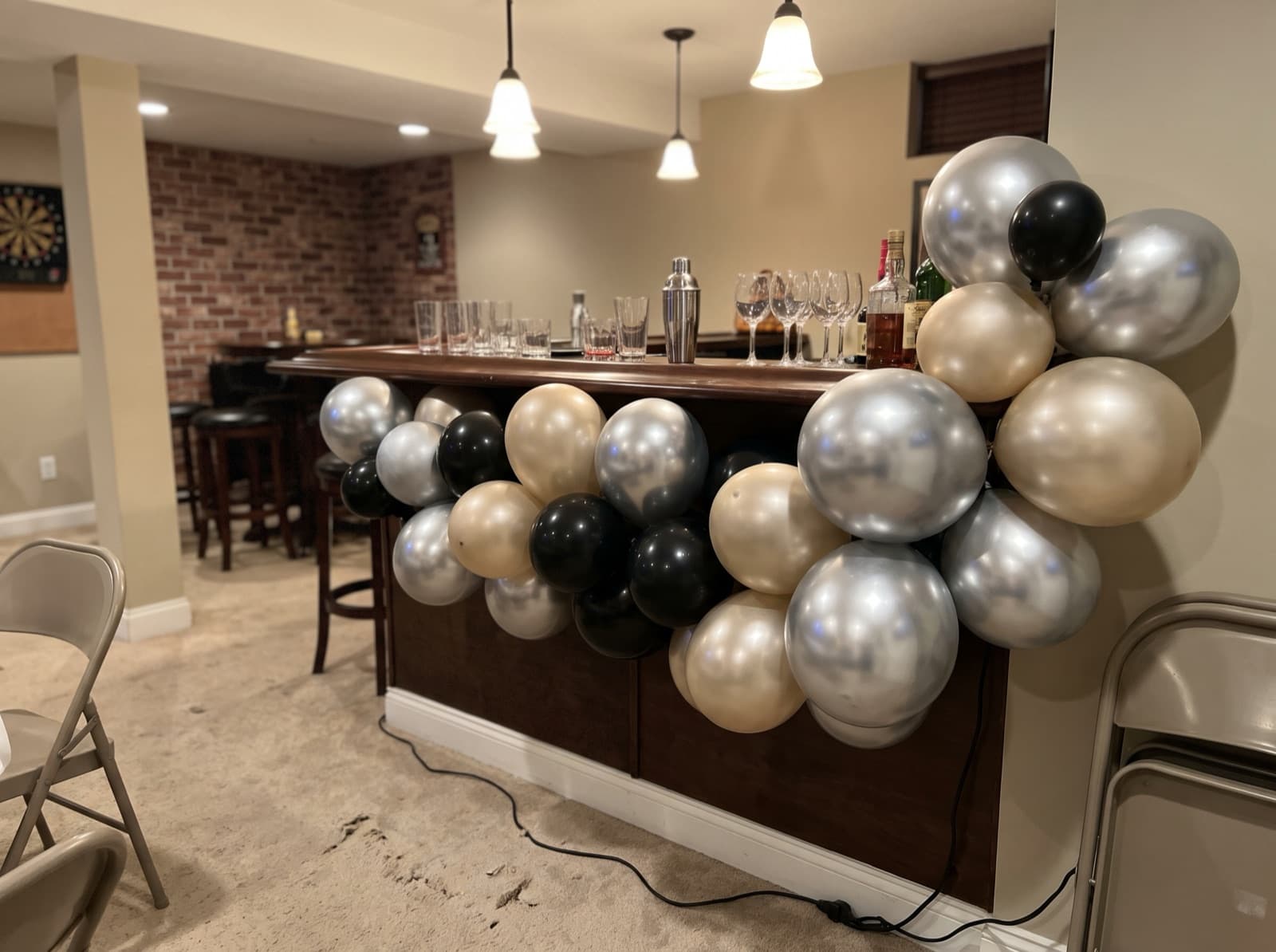 Chrome balloon garland over a home bar for New Year's Eve