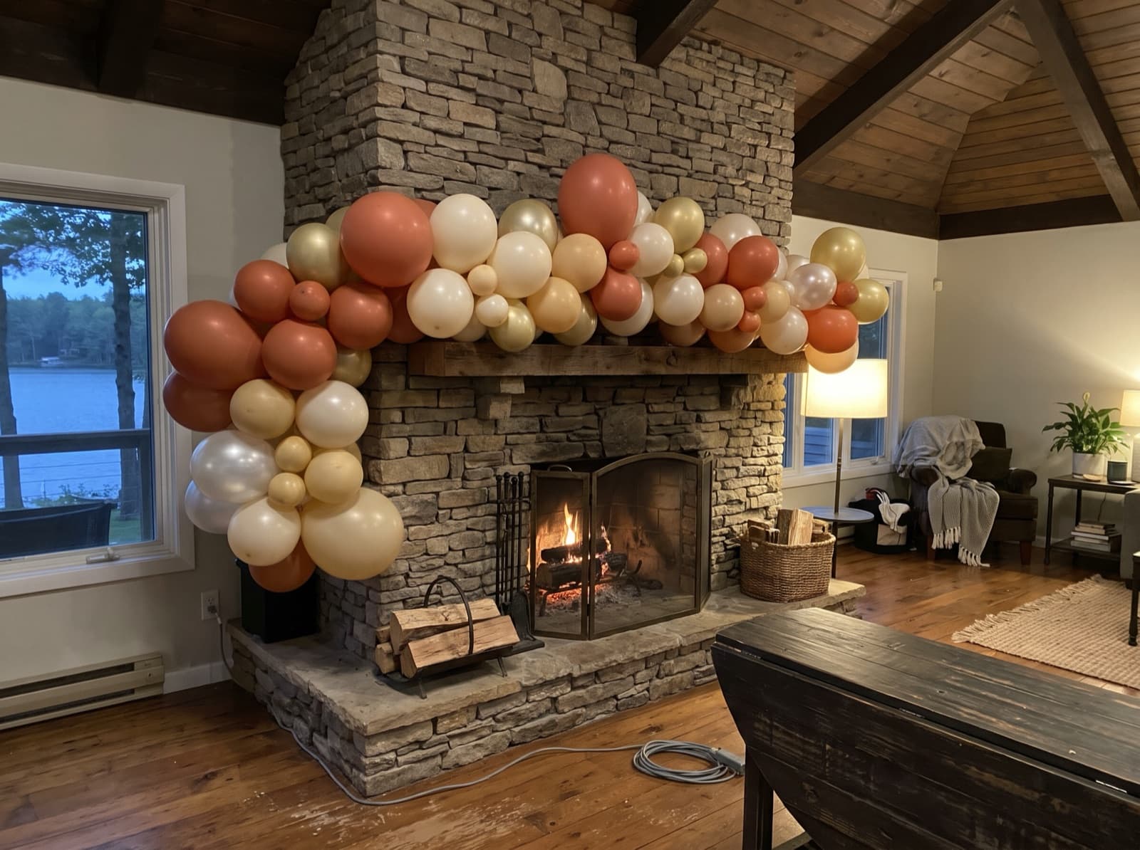 Organic balloon garland on a stacked-stone fireplace mantel