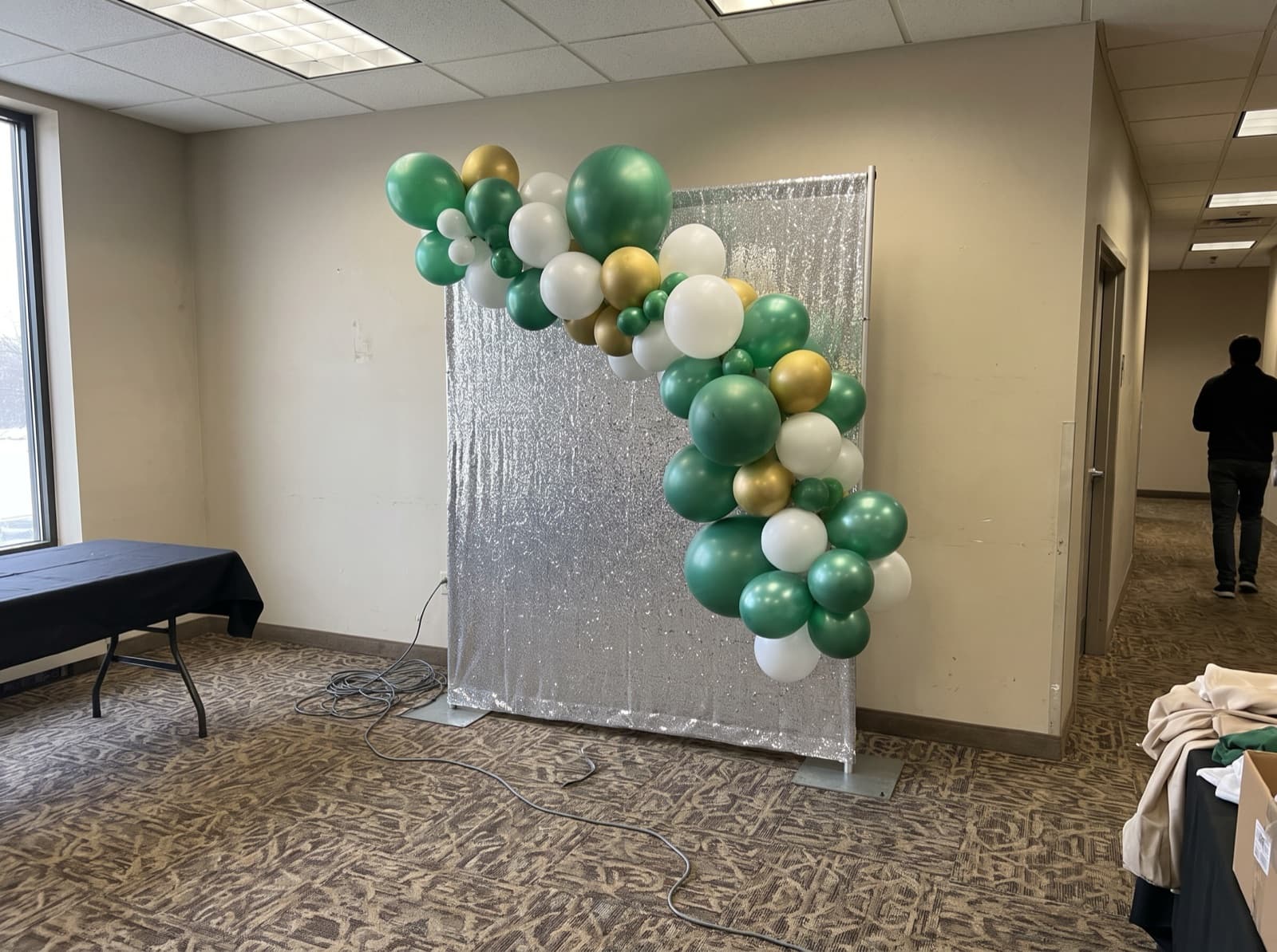 Balloon garland over a silver shimmer wall