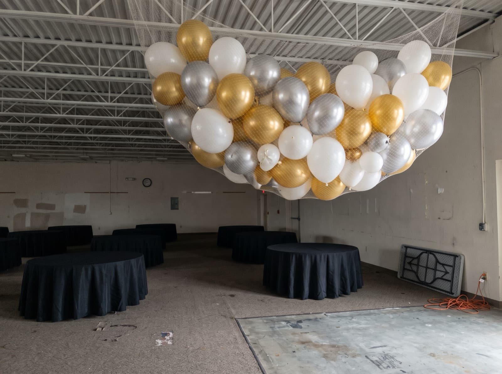 Balloon drop net rigged overhead before a countdown