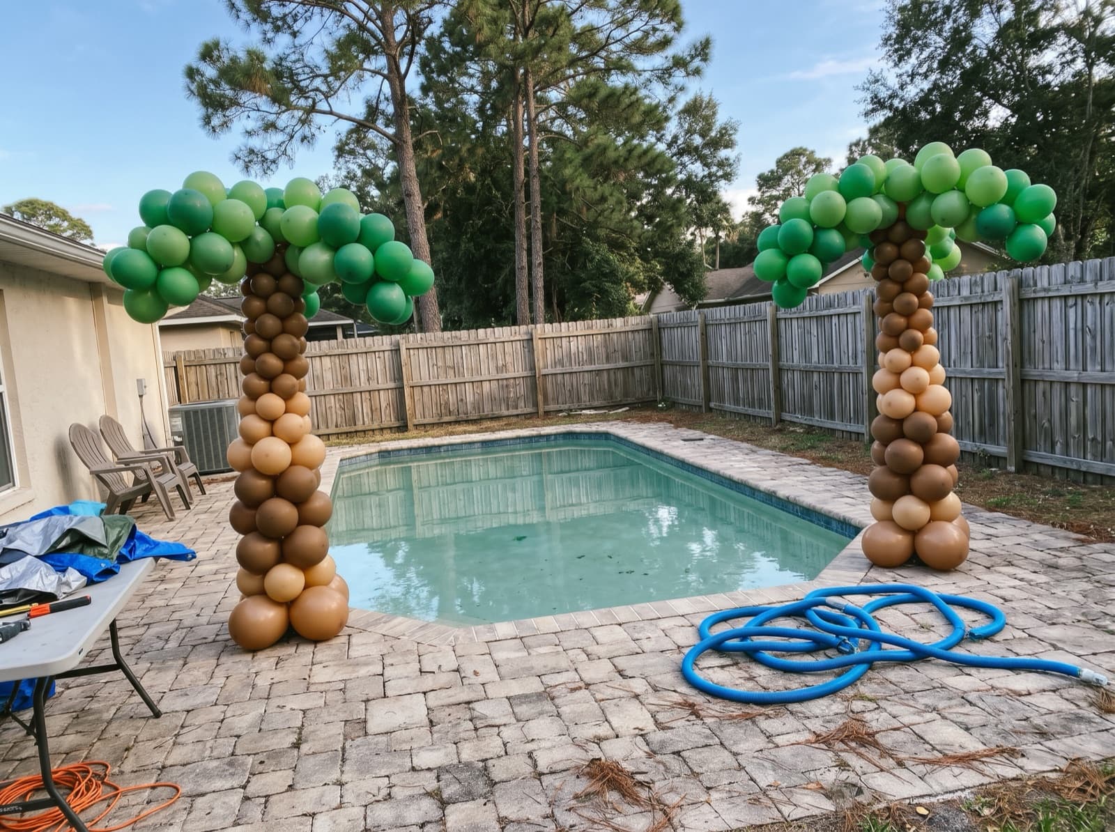 Balloon palm trees beside a backyard pool