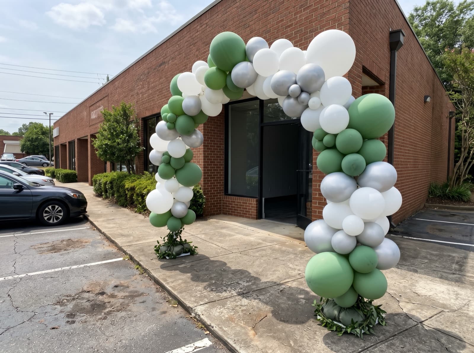 Giant balloon arch over a shop entrance in a brick shopping village