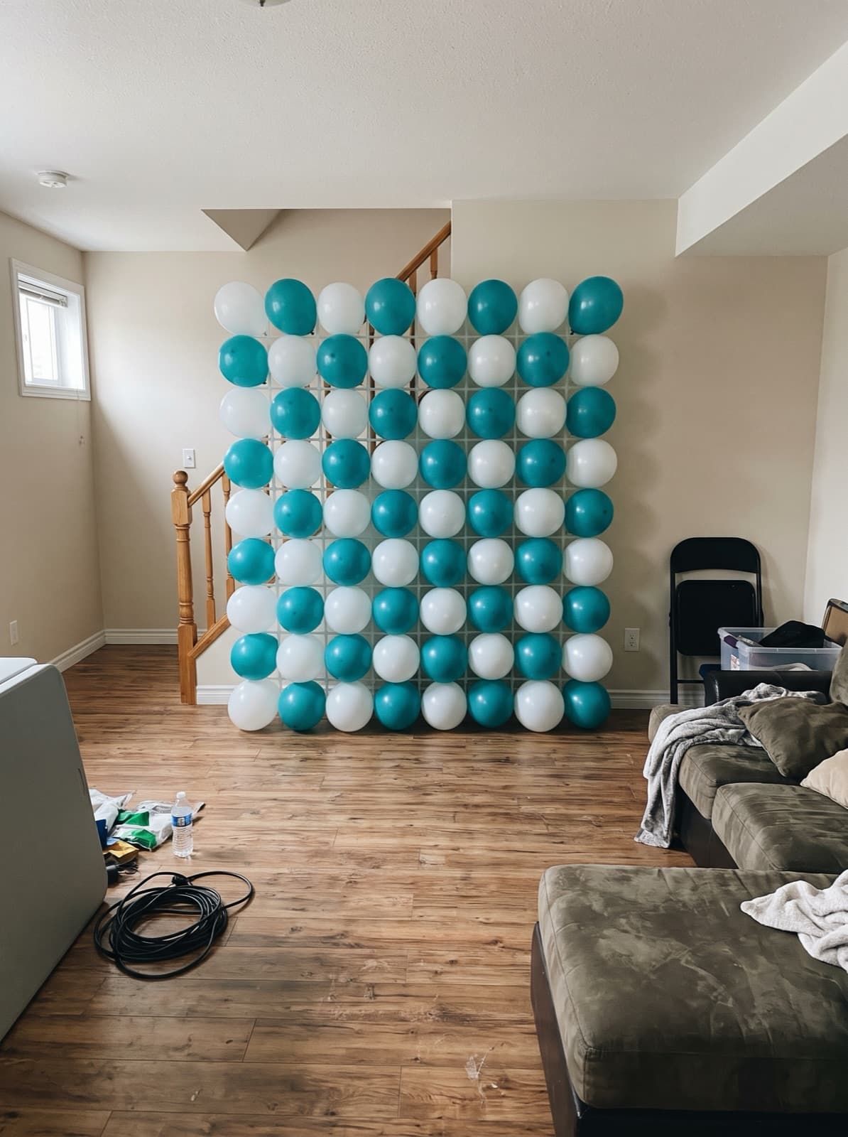 Grid balloon wall in a teal and white checkerboard